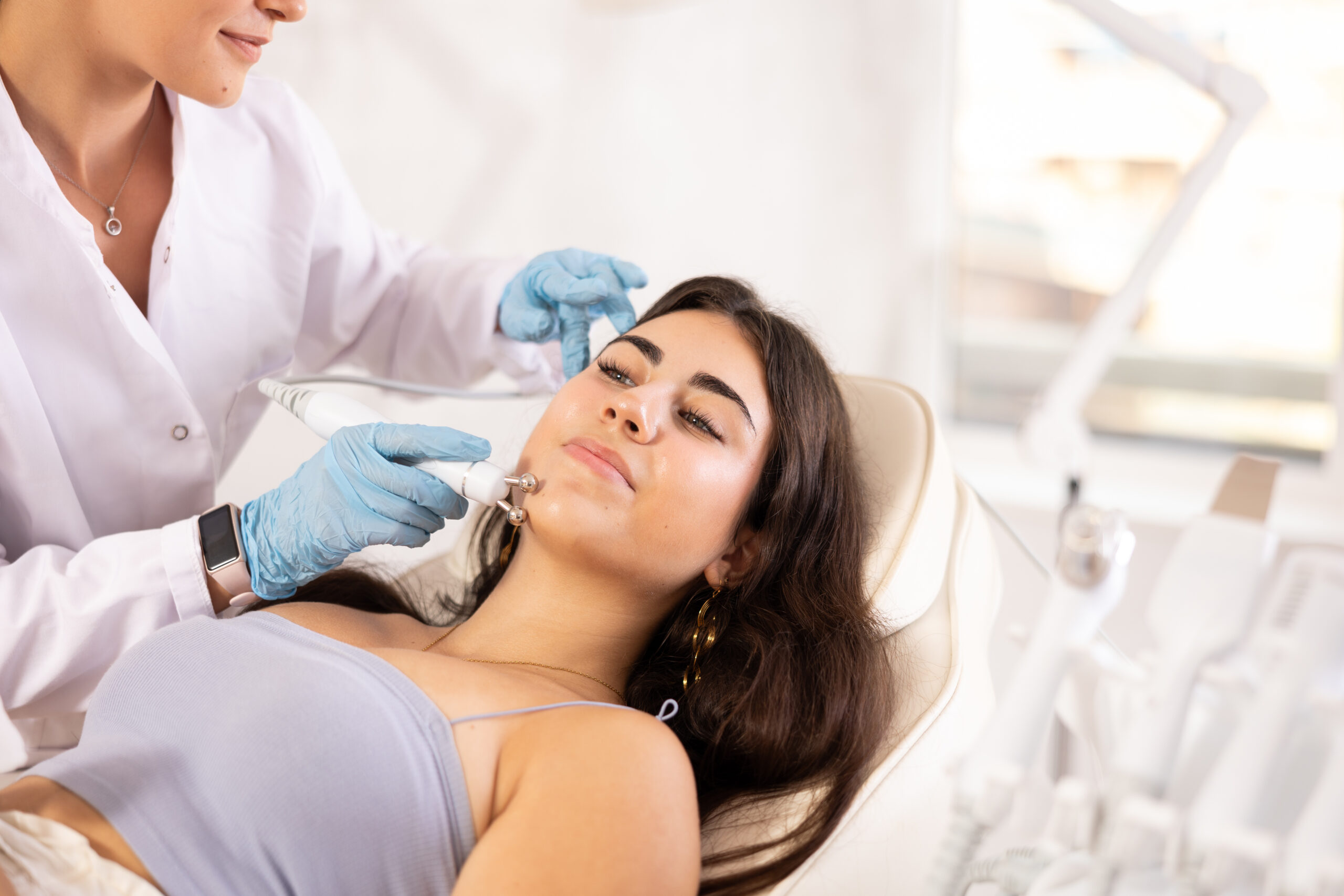 Young girl receiving radiofrequency skin tightening at Lentz Plastic Surgery.